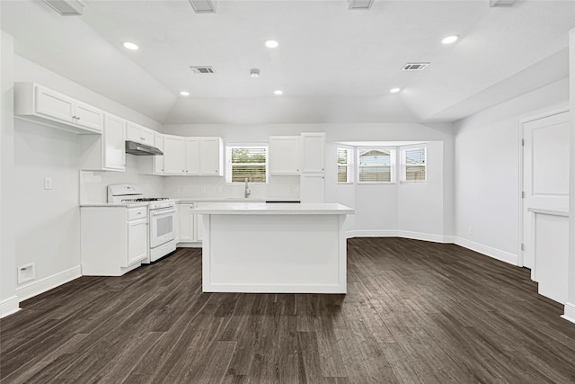 639 Ames St, Spring, TX 77373 - kitchen featuring white range with gas cooktop, under cabinet range hood, light countertops, dark wood-type flooring, and a center island