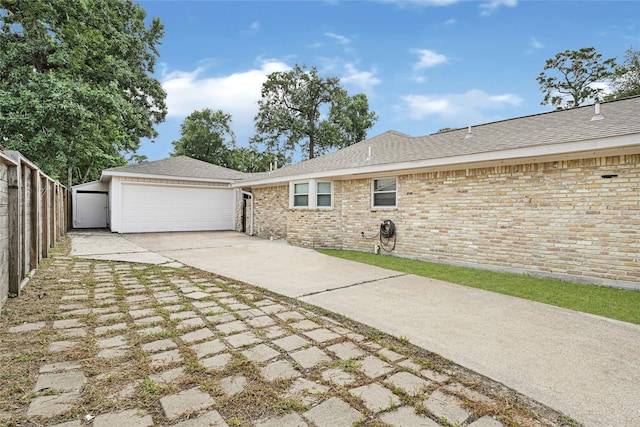 639 Ames St, Spring, TX 77373 - view of property exterior featuring brick siding, a garage, and roof with shingles