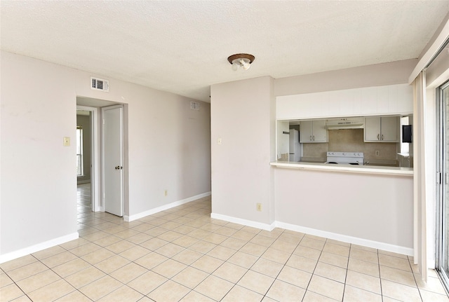 1950 Spenwick Dr Unit 408, Houston, TX 77055 - unfurnished living room with light tile patterned flooring and a textured ceiling