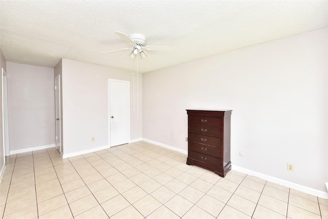 1950 Spenwick Dr Unit 408, Houston, TX 77055 - spare room featuring ceiling fan, a textured ceiling, and light tile patterned floors