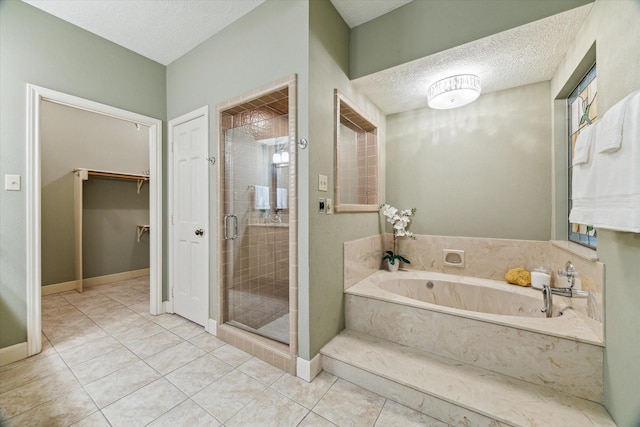 6019 Oak Creek Ln, Spring, TX 77379 - bathroom with a garden tub, a shower stall, tile patterned flooring, a textured ceiling, and a spacious closet