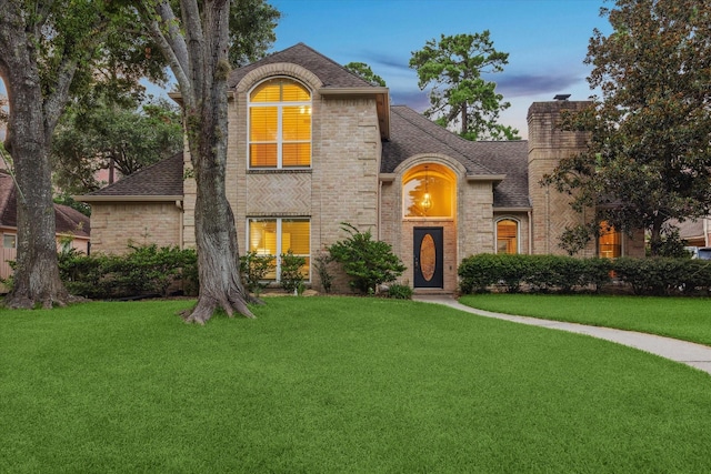 6019 Oak Creek Ln, Spring, TX 77379 - french country inspired facade featuring roof with shingles, a lawn, and brick siding