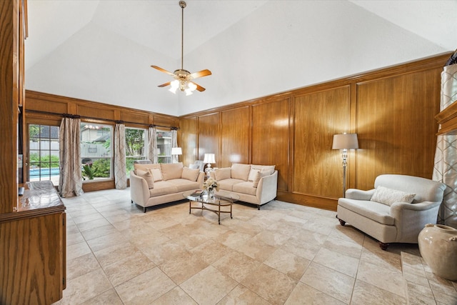 6019 Oak Creek Ln, Spring, TX 77379 - living area featuring high vaulted ceiling, ceiling fan, and wood walls