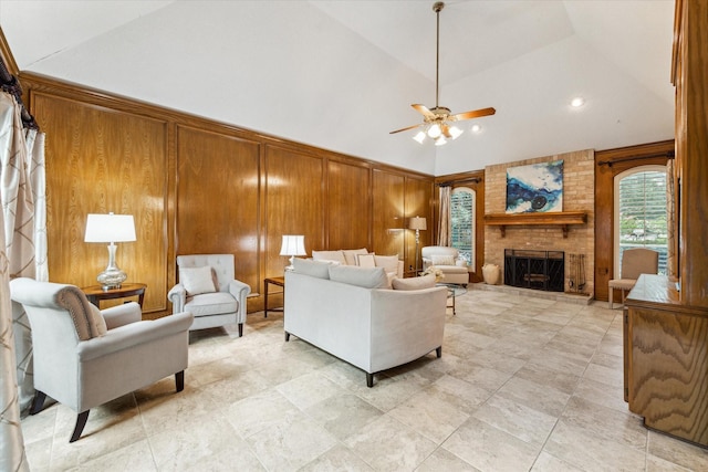 6019 Oak Creek Ln, Spring, TX 77379 - living area featuring wooden walls, ceiling fan, a fireplace, high vaulted ceiling, and recessed lighting