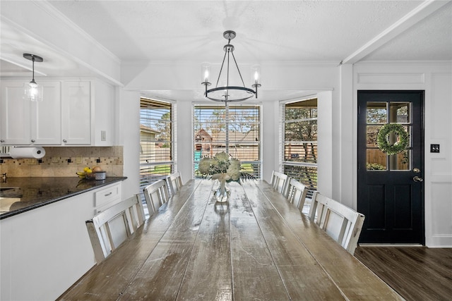 19702 Sweet Forest Ln, Humble, TX 77346 - dining area featuring a chandelier, wood finished floors, a textured ceiling, and ornamental molding
