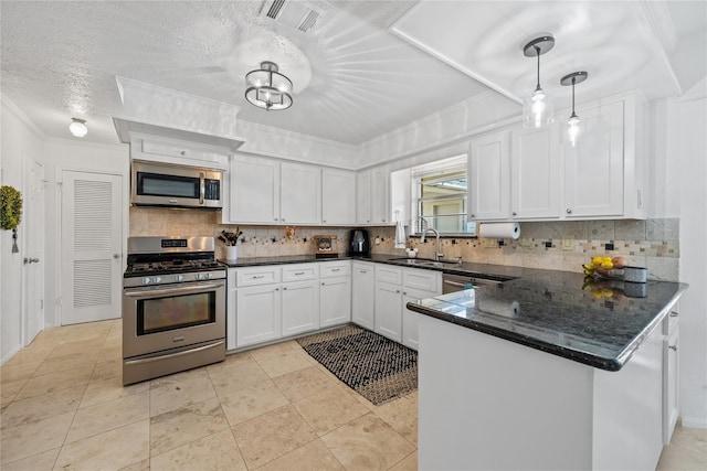 19702 Sweet Forest Ln, Humble, TX 77346 - kitchen featuring stainless steel appliances, white cabinetry, tasteful backsplash, a peninsula, and crown molding