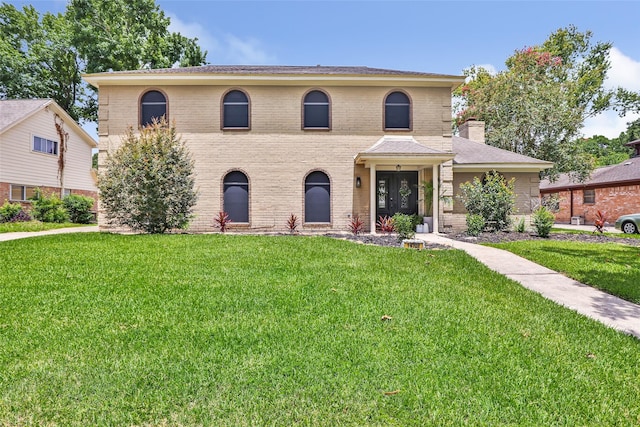 19702 Sweet Forest Ln, Humble, TX 77346 - view of front of home with brick siding and a front yard