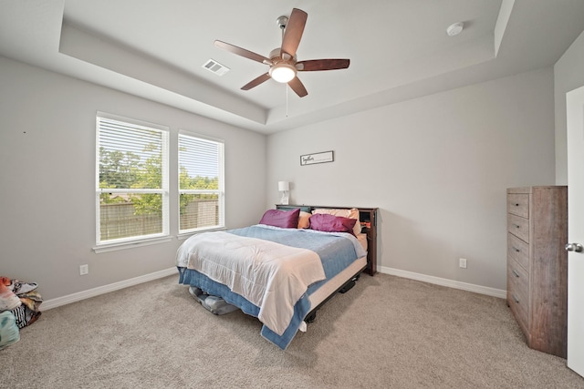 2849 Terrace Grove Dr, Conroe, TX 77304 - bedroom with a raised ceiling, light colored carpet, and a ceiling fan