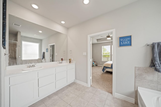 2849 Terrace Grove Dr, Conroe, TX 77304 - bathroom featuring ensuite bath, double vanity, a tub to relax in, tile patterned floors, and recessed lighting