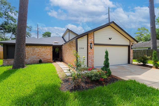 11906 Rowood Dr, Houston, TX 77070 - view of front of house featuring brick siding, driveway, and a garage
