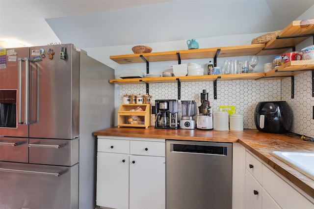 11906 Rowood Dr, Houston, TX 77070 - kitchen featuring stainless steel appliances, open shelves, and tasteful backsplash