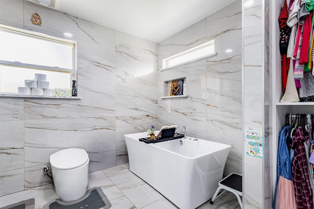 11906 Rowood Dr, Houston, TX 77070 - full bath with tile walls, a freestanding bath, and marble finish floors