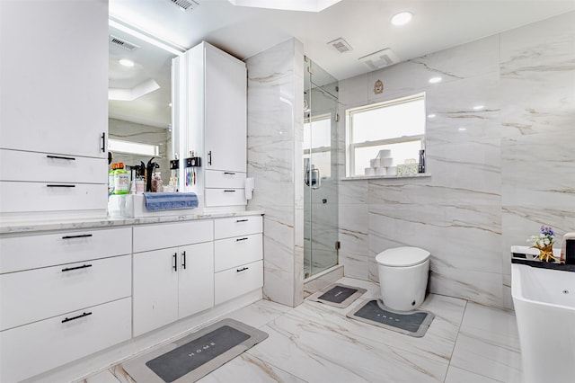 11906 Rowood Dr, Houston, TX 77070 - bathroom with vanity, a marble finish shower, marble tiled floors, a freestanding bath, and tile walls