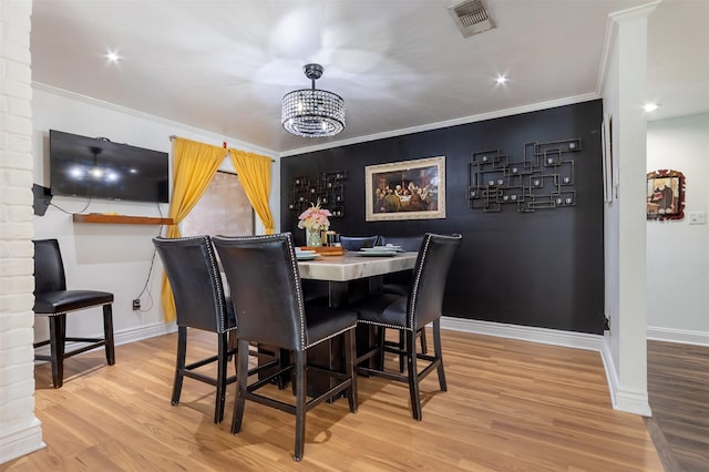 11906 Rowood Dr, Houston, TX 77070 - dining space featuring a chandelier, wood finished floors, and ornamental molding