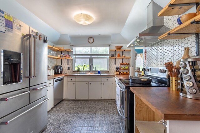 11906 Rowood Dr, Houston, TX 77070 - kitchen featuring open shelves, appliances with stainless steel finishes, wooden counters, and vaulted ceiling