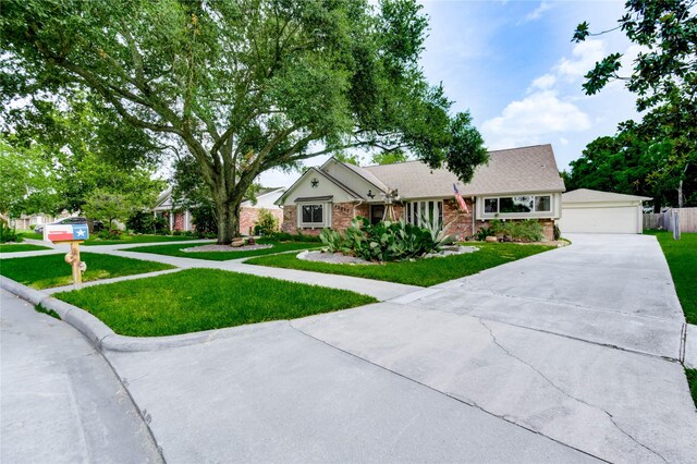 12327 Meadowhollow Dr, Meadows Place, TX 77477 - ranch-style house with a front lawn, a detached garage, and brick siding
