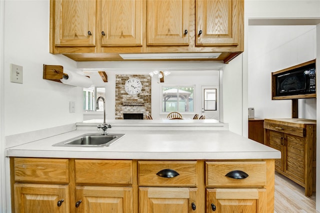 12327 Meadowhollow Dr, Meadows Place, TX 77477 - kitchen with black microwave, light countertops, and plenty of natural light