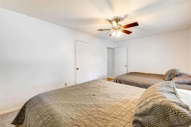 12327 Meadowhollow Dr, Meadows Place, TX 77477 - carpeted bedroom with baseboards and ceiling fan