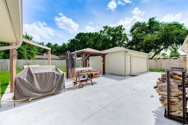 12327 Meadowhollow Dr, Meadows Place, TX 77477 - fenced backyard with a gazebo, a patio, a detached garage, and area for grilling