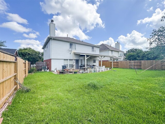 21307 Walden Grove Ln, Katy, TX 77450 - back of house with a patio, a fenced backyard, and a chimney