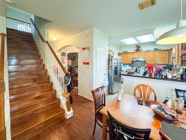 21307 Walden Grove Ln, Katy, TX 77450 - dining room with stairs, arched walkways, and wood finished floors