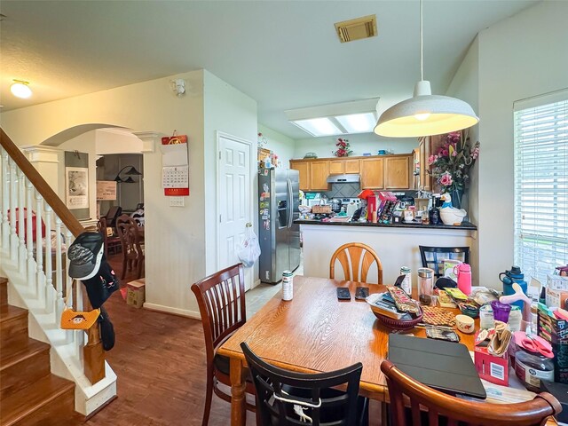 21307 Walden Grove Ln, Katy, TX 77450 - dining room featuring stairs, arched walkways, and wood finished floors