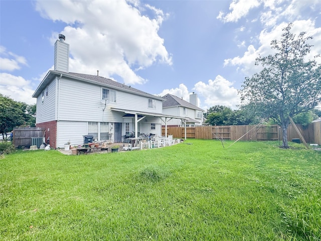 21307 Walden Grove Ln, Katy, TX 77450 - rear view of house with a patio area, a fenced backyard, and a chimney