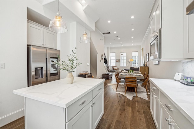 8764 Park Kolbe Ln, Houston, TX 77080 - kitchen with appliances with stainless steel finishes, dark wood-style floors, white cabinetry, recessed lighting, and light stone counters