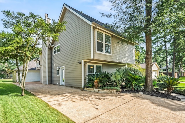 3019 Ramblewood Rd, Montgomery, TX 77356 - view of home's exterior featuring a chimney, a garage, a yard, and driveway