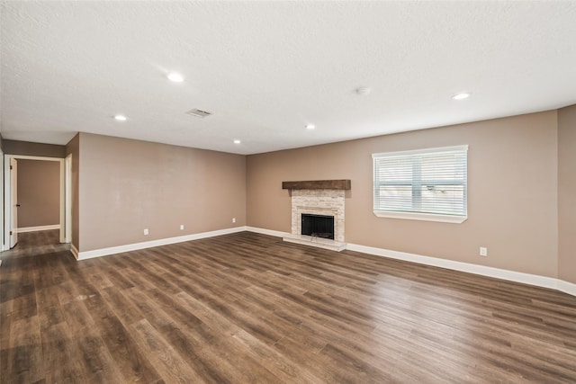 3019 Ramblewood Rd, Montgomery, TX 77356 - unfurnished living room with dark wood-type flooring, recessed lighting, and a fireplace