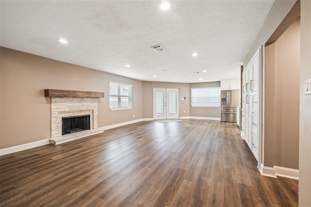 3019 Ramblewood Rd, Montgomery, TX 77356 - unfurnished living room with dark wood finished floors, a textured ceiling, a fireplace, and recessed lighting