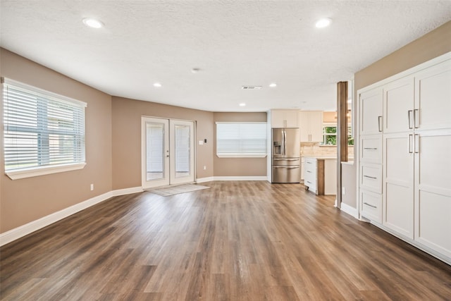 3019 Ramblewood Rd, Montgomery, TX 77356 - unfurnished living room featuring healthy amount of natural light, dark wood-style flooring, recessed lighting, and french doors