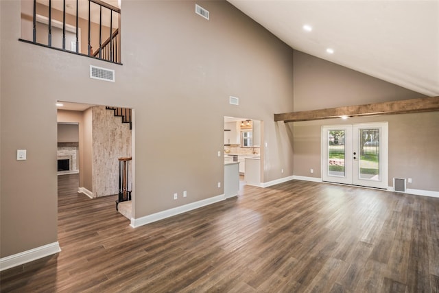 3019 Ramblewood Rd, Montgomery, TX 77356 - unfurnished living room with french doors, dark wood finished floors, high vaulted ceiling, a fireplace, and stairway