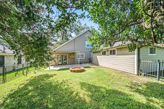 3019 Ramblewood Rd, Montgomery, TX 77356 - rear view of house with a fenced backyard, a patio area, french doors, and an outdoor fire pit