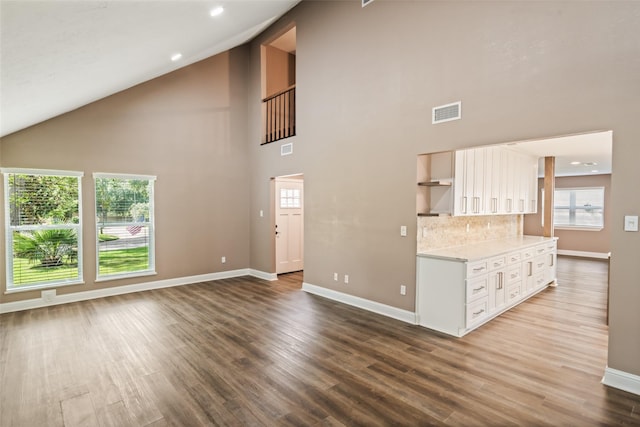 3019 Ramblewood Rd, Montgomery, TX 77356 - unfurnished living room with high vaulted ceiling and wood finished floors