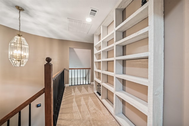3019 Ramblewood Rd, Montgomery, TX 77356 - corridor featuring light carpet, an upstairs landing, and a chandelier