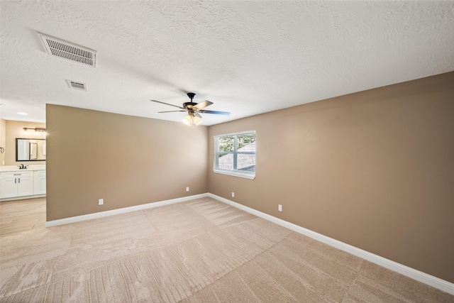 3019 Ramblewood Rd, Montgomery, TX 77356 - empty room featuring a ceiling fan, light carpet, and a textured ceiling
