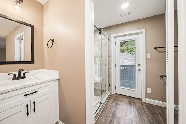 3019 Ramblewood Rd, Montgomery, TX 77356 - full bath featuring a shower stall, vanity, and wood finished floors