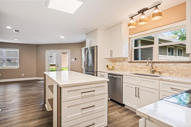 3019 Ramblewood Rd, Montgomery, TX 77356 - kitchen with stainless steel appliances, dark wood-style flooring, decorative backsplash, white cabinets, and recessed lighting