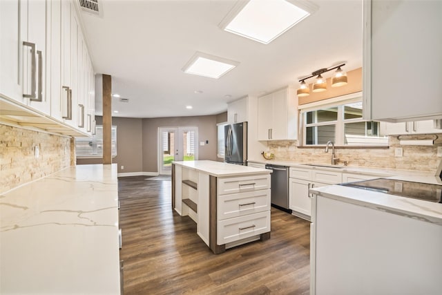 3019 Ramblewood Rd, Montgomery, TX 77356 - kitchen featuring appliances with stainless steel finishes, light stone counters, tasteful backsplash, white cabinetry, and recessed lighting