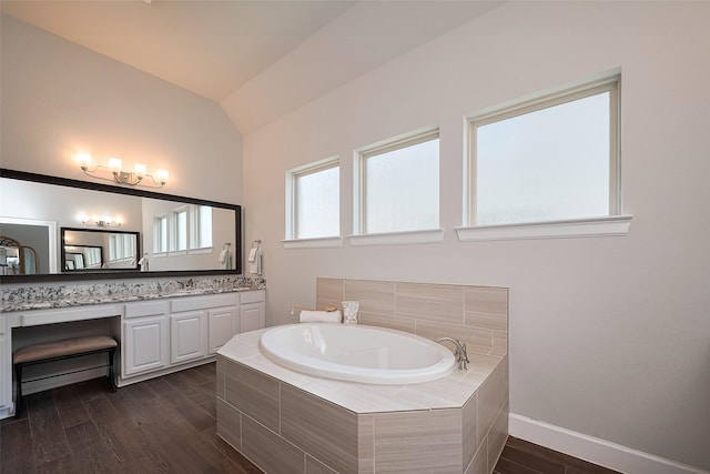 7707 Leighton Trl, Pasadena, TX 77505 - bathroom featuring vanity, a garden tub, wood finished floors, and lofted ceiling