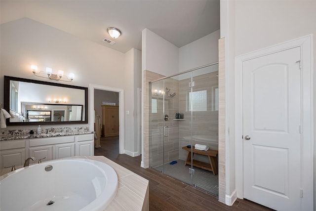 7707 Leighton Trl, Pasadena, TX 77505 - bathroom featuring a shower stall, vanity, wood finished floors, and a bath