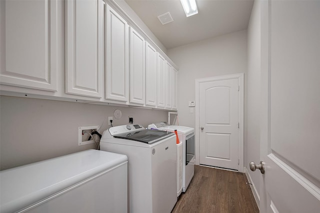 7707 Leighton Trl, Pasadena, TX 77505 - laundry area featuring cabinet space, washing machine and dryer, and dark wood-style flooring