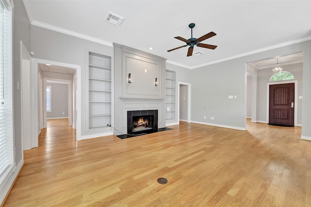 3519 E Pine Brook Way, Houston, TX 77059 - unfurnished living room featuring built in shelves, a ceiling fan, light wood finished floors, ornamental molding, and a tiled fireplace