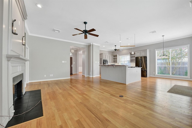 3519 E Pine Brook Way, Houston, TX 77059 - unfurnished living room with a ceiling fan, ornamental molding, a tiled fireplace, light wood finished floors, and a chandelier