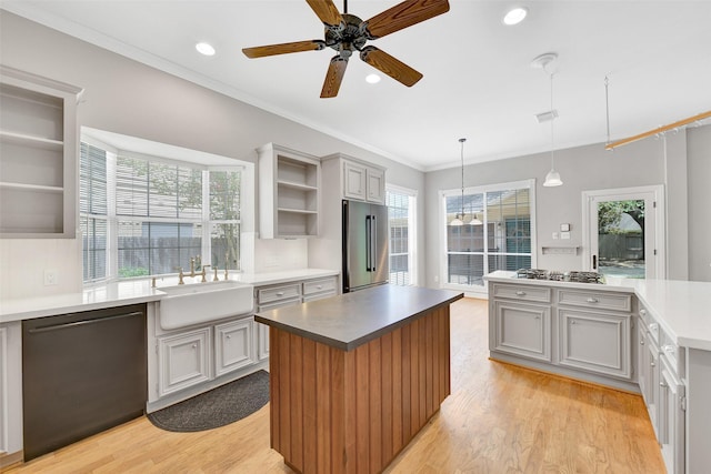 3519 E Pine Brook Way, Houston, TX 77059 - kitchen featuring open shelves, appliances with stainless steel finishes, a kitchen island, light wood-type flooring, and ceiling fan