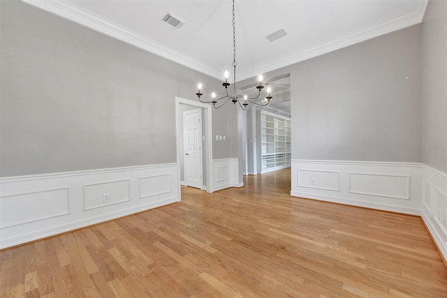 3519 E Pine Brook Way, Houston, TX 77059 - unfurnished dining area with a chandelier, light wood finished floors, crown molding, wainscoting, and a decorative wall