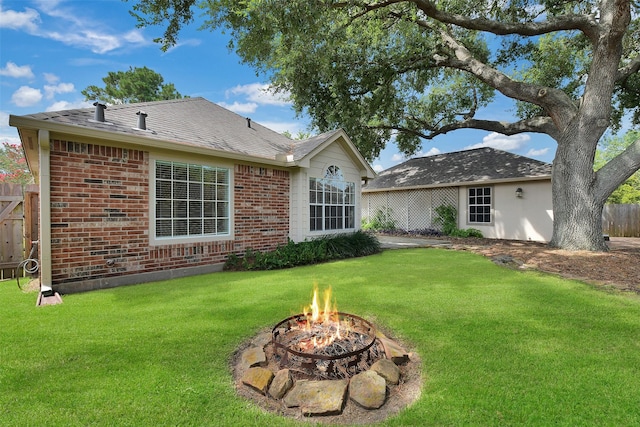 3519 E Pine Brook Way, Houston, TX 77059 - back of property featuring an outdoor fire pit and brick siding