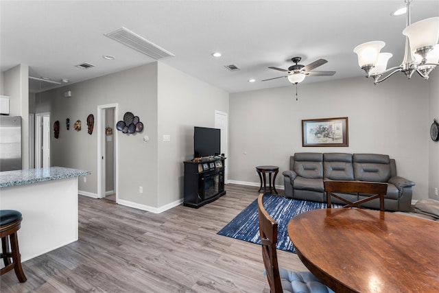 16887 Balmoral St, Montgomery, TX 77316 - living room with wood finished floors, ceiling fan, recessed lighting, and a chandelier