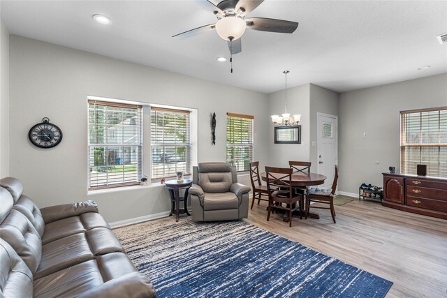 16887 Balmoral St, Montgomery, TX 77316 - living room featuring a chandelier, a ceiling fan, light wood-type flooring, and recessed lighting